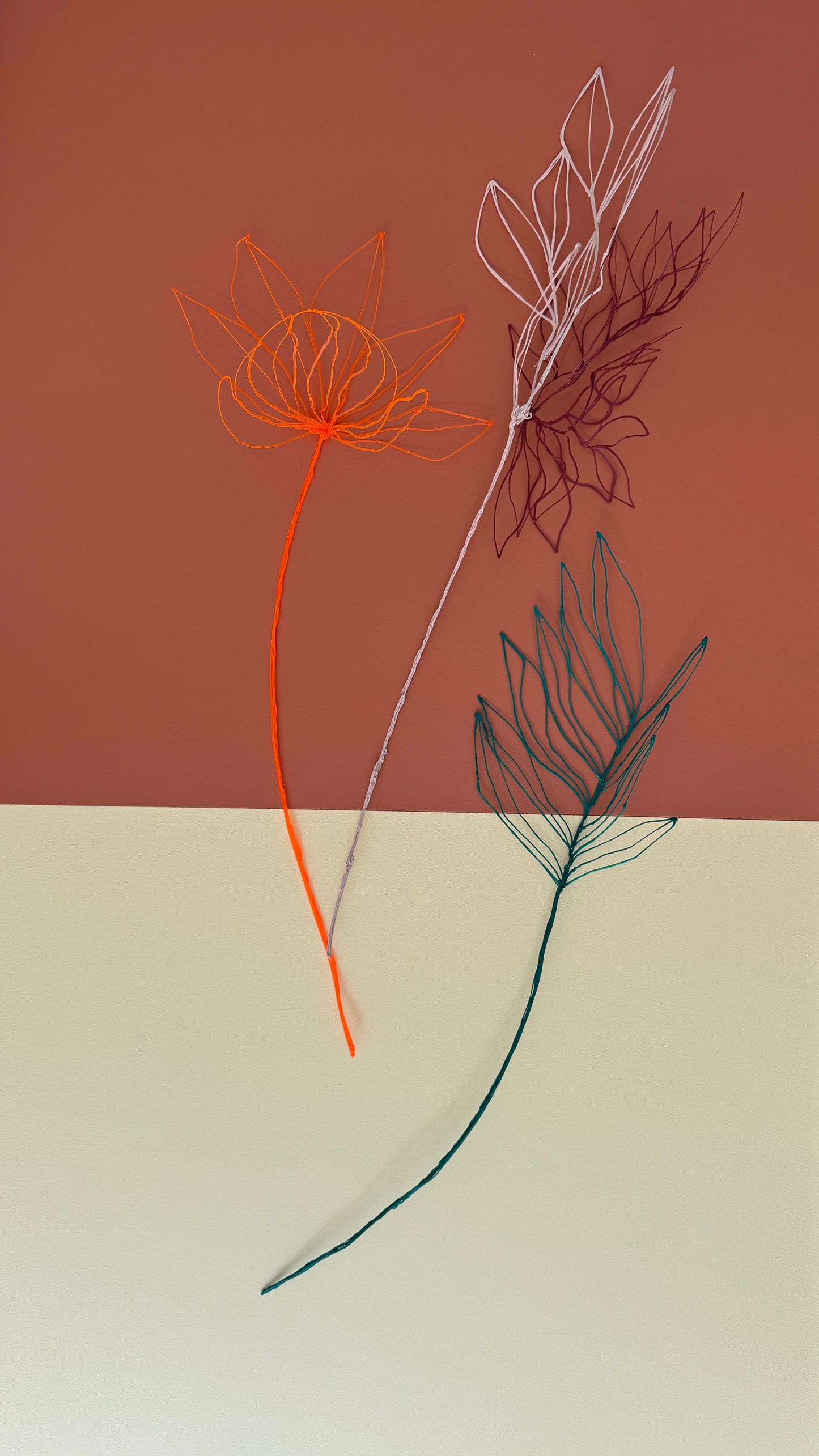 Orange flower + light pink/brown flower + green leaves