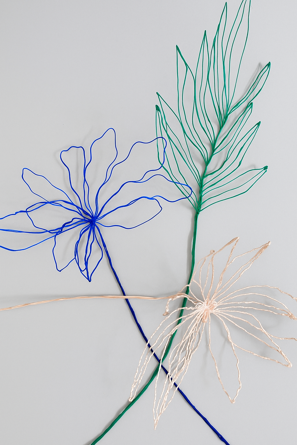 Blue flower + green leaves + light pink flower